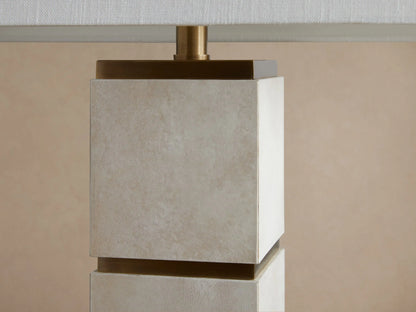 Micha Tall Table Lamp, front view. White rectangular linen shade over a tall, light parchment leather base with brass accents.