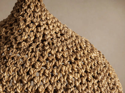 Canela 15" Pendant, bell-shaped, handwoven natural banana rope shade with textured weave, hanging from a black cord.