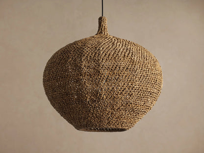 Canela 26" Pendant: round, handwoven natural banana rope light fixture hanging, with a warm glow from inside.