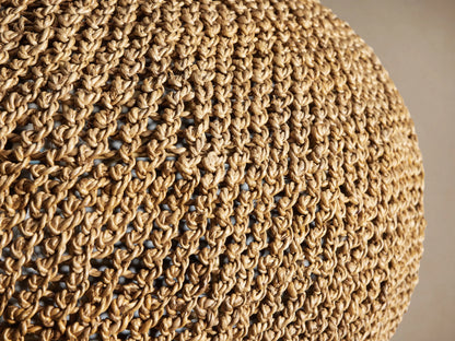 Canela 26" Pendant, a rounded natural banana rope handwoven light fixture with an open weave, hanging from a black cord.