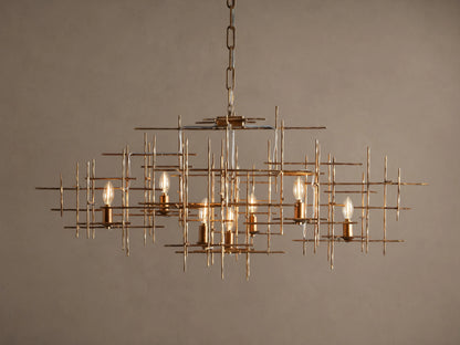Fritz Chandelier: Hand-hammered antique gold iron rectangular chandelier with an intricate grid design and seven exposed, lit bulbs.