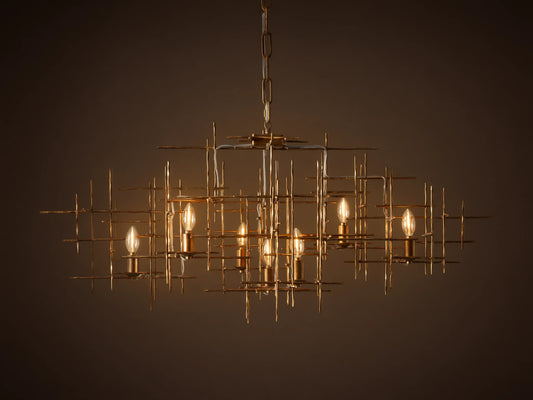 Fritz Chandelier: Hand-hammered antique gold iron rectangular chandelier with an intricate grid design and seven exposed, lit bulbs.