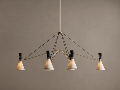Ramsey Linear Chandelier with a satin brass frame, matte black accents, and six glowing white conical fabric shades.
