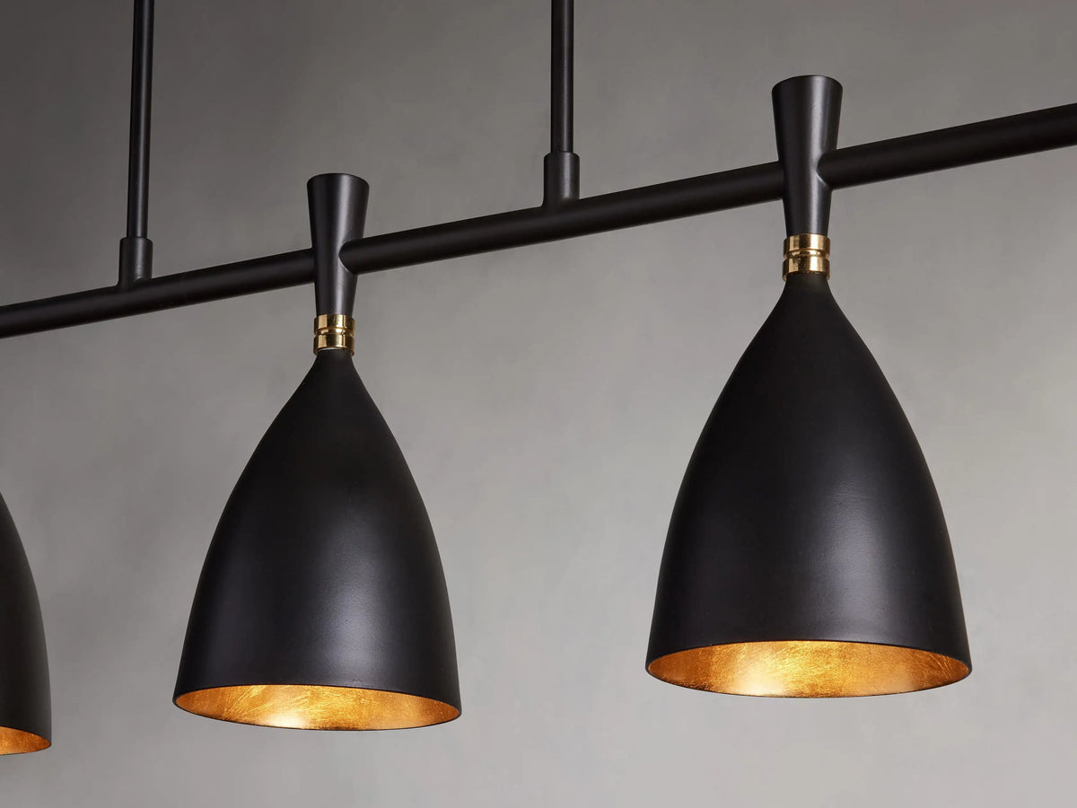 Jacarra Linear Chandelier with five matte black shades and gold leaf interiors, suspended from a metal bar finished in old bronze.