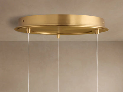 Casen Round Chandelier ceiling plate, satin brass, flush-mounted on a light ceiling, with three thin white suspension cables.