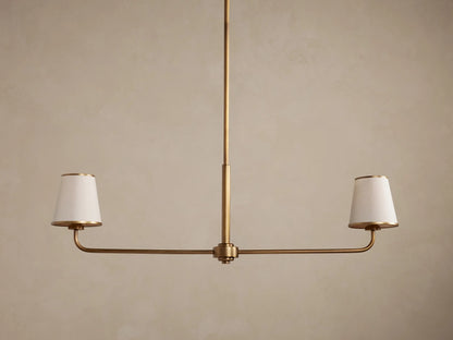 Adria 2-Light Chandelier: Bronze-finished frame with two glowing, tapered off-white fabric shades on a horizontal bar.