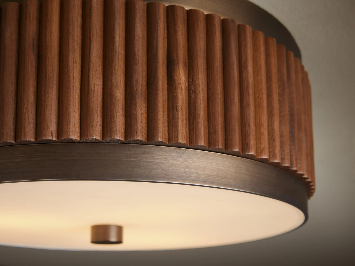 Ceiling-mounted light fixture with a round, ribbed wooden frame and a white frosted glass base, featuring a bronze accent.