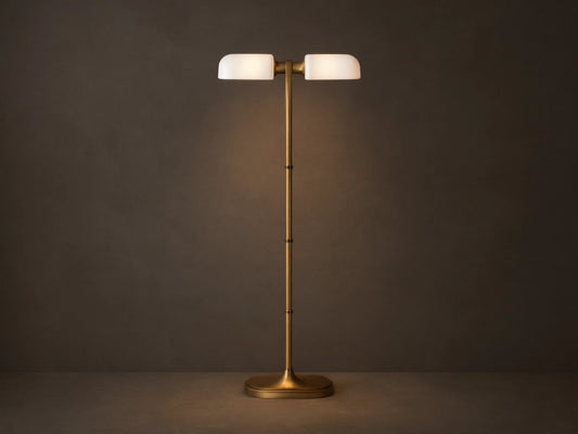 Zayd Floor Lamp: elegant brass with two illuminated oblong opal glass shades and an oval base, standing on a wooden floor.