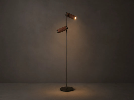 Decan Task Floor Lamp: bronze metal, two fluted walnut wood shades, one illuminated, casting a warm glow.