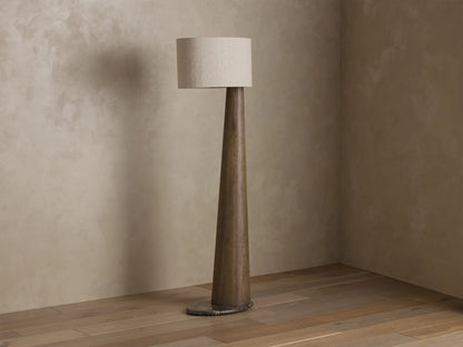 Close-up of the illuminated beige textured linen oval lamp shade, glowing warmly.