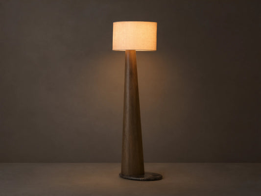 Front view of a tall floor lamp with a dark brown tapered wood base and a light beige rectangular fabric shade, emitting warm light.