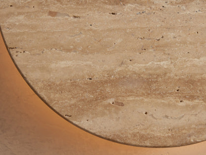 Odette Outdoor Sconce: Oval natural stone with beige & cream horizontal veining, mounted on a light wall.