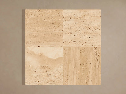 Natural beige stone Odette Outdoor Sconce, horizontally veined, illuminated from behind with a warm glow.
