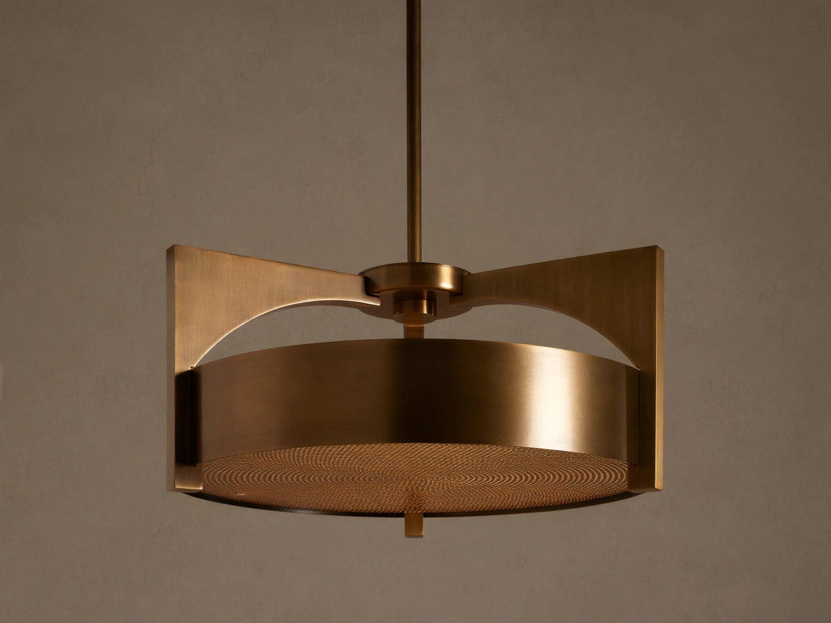 Burnished brass Alastair Pendant. Cylindrical shade, angular side supports, and a textured acrylic diffuser, hanging from above.
