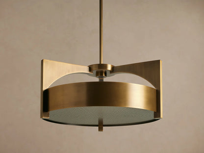 Burnished brass Alastair Pendant. Cylindrical shade, angular side supports, and a textured acrylic diffuser, hanging from above.