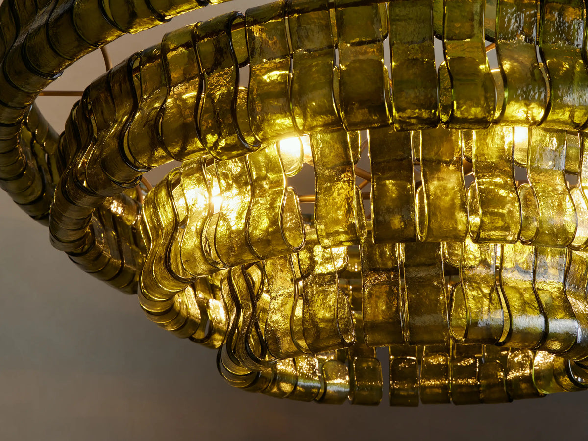 Dark green Ghiaccio Round Chandelier, made of tiered curved glass, suspended by a brass chain.