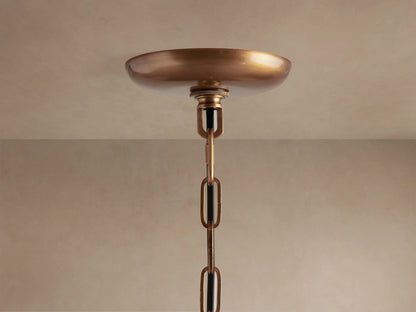 Close-up of Ghiaccio Pendant with textured, olive green curved glass pieces glowing warmly from internal light source.