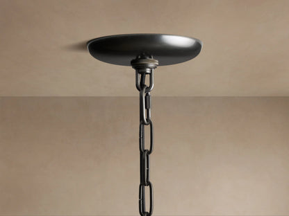 Close-up of Ghiaccio Pendant, featuring curved, textured amber-green glass panels glowing brightly from within.