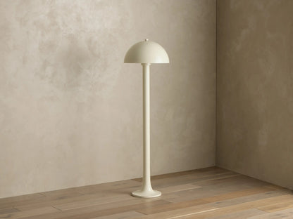Front view of a light beige Floor Lamp with a mushroom-shaped shade, standing on a wooden floor and casting warm light.
