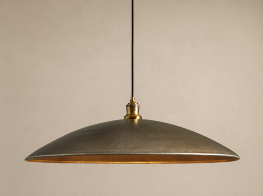 Recycled Metal Fan Pendant with wide, hammered brass-finished shade and reflective golden interior, hanging from a black cord.