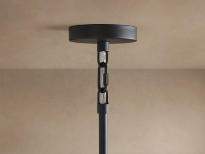 Saige Round Chandelier ceiling mount: black metal round plate, black hanging rod with internal silver-toned chain, on a beige ceiling.
