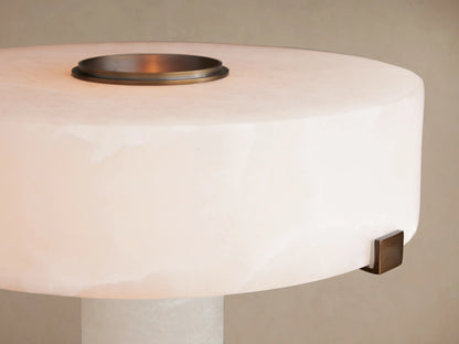 Chayla Table Lamp. Close-up of milky white glowing alabaster shade with antique brass ring on top and bronze side accent.