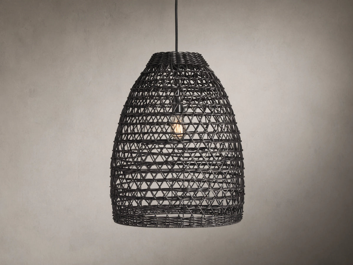 Braemar Outdoor Black Pendant with a woven all-weather wicker shade, hanging from a black fabric-wrapped cord, bulb visible within.