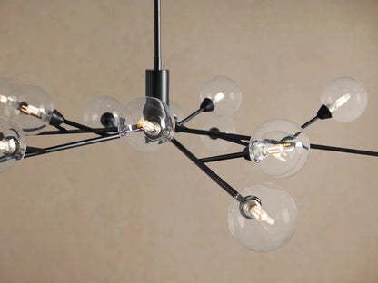 Apollo Round Chandelier featuring a black metal frame with multiple clear glass globe bulbs, suspended against a beige background.