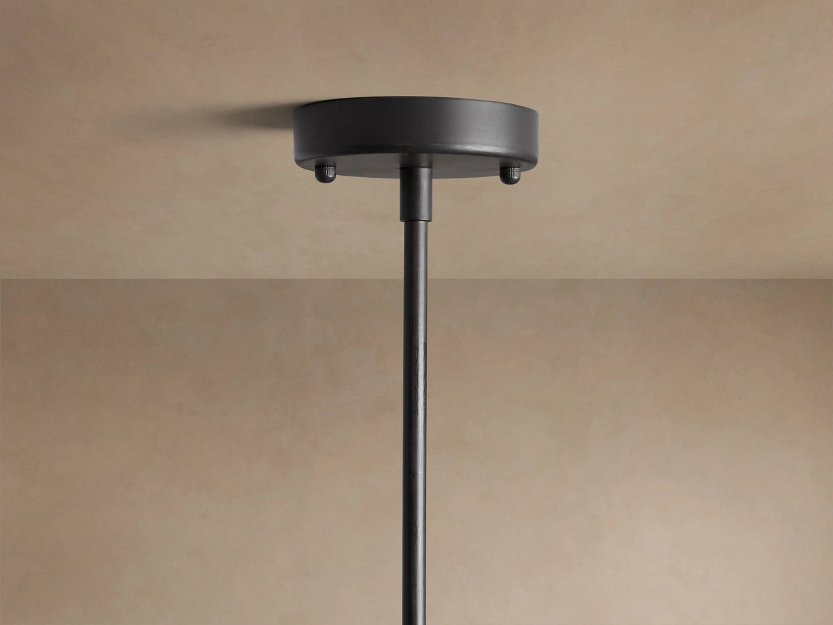 Apollo Round Chandelier, black iron arms with multiple clear glass globes, showing internal G9 LED bulbs, against beige wall.