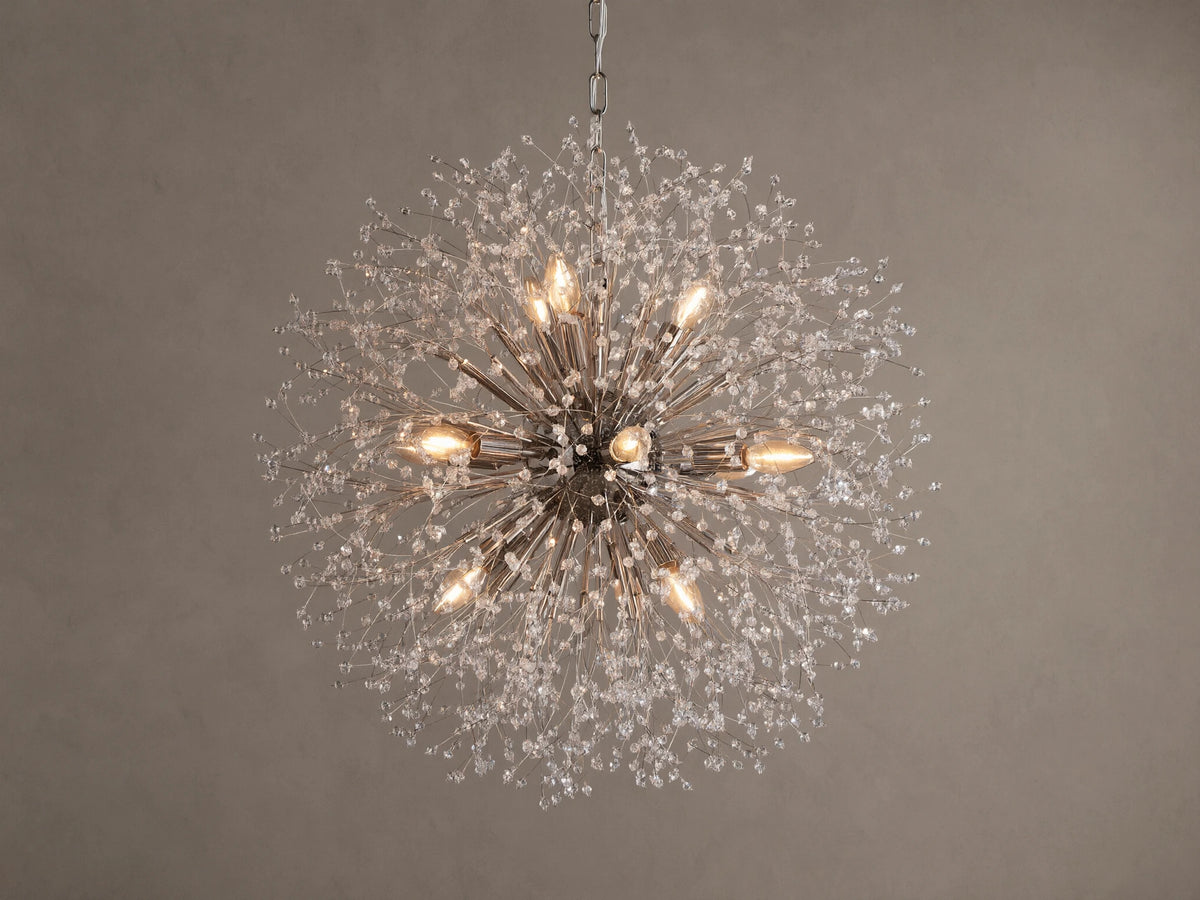 Dandelion Round Chandelier, nickel-plated with many thin arms radiating out, adorned with clear glass crystals and warm lit bulbs.