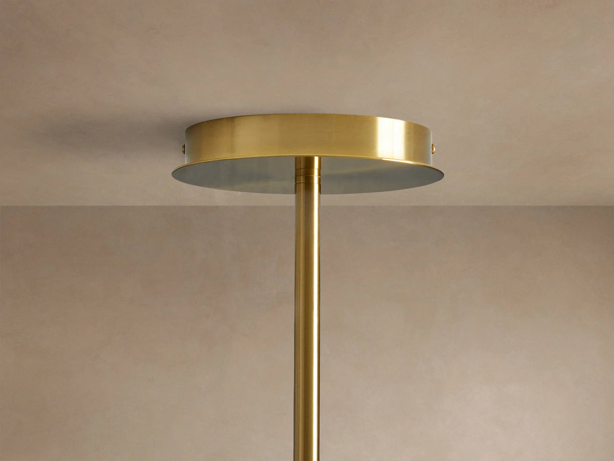 Close-up of Roscoe Chandelier with plated brass frame, intersecting rods, and clear glass globes, some showing LED bulbs.