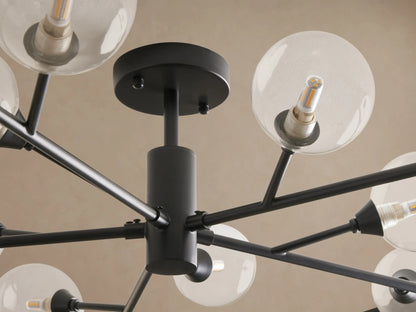 Apollo Flush Mount: Black modern sputnik-style ceiling light with clear globe bulbs on radiating arms, mounted on a brown ceiling.