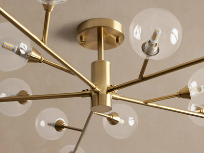 Apollo Flush Mount: Modern gold flush mount light fixture with clear globe bulbs radiating from a central hub on a ceiling.