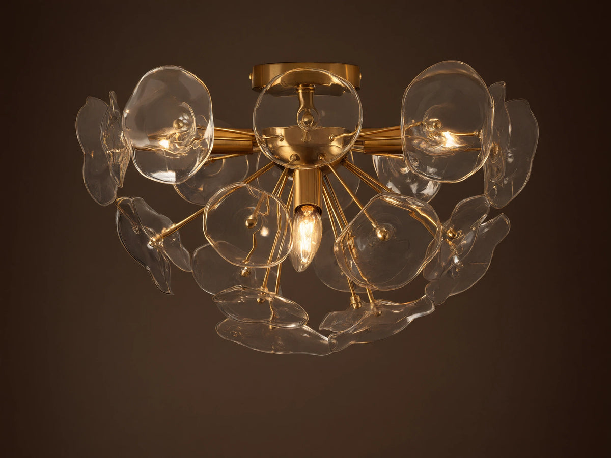 Gold Lily Flush Mount with multiple clear glass petals arranged around glowing bulbs, mounted on a neutral ceiling.