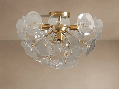 Gold Lily Flush Mount with multiple clear glass petals arranged around glowing bulbs, mounted on a neutral ceiling.