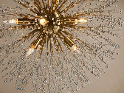 Round Dandelion Chandelier with a gold core, radiating nickel arms tipped with sparkling clear crystals, hanging from above.