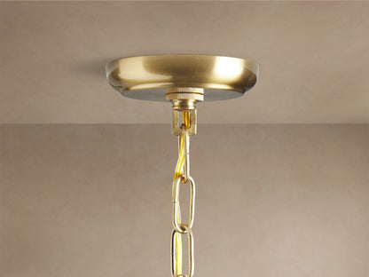 Dandelion Round Chandelier, close-up. Gold-toned central hub, radiating metal arms with clear crystals & warm glowing bulbs.