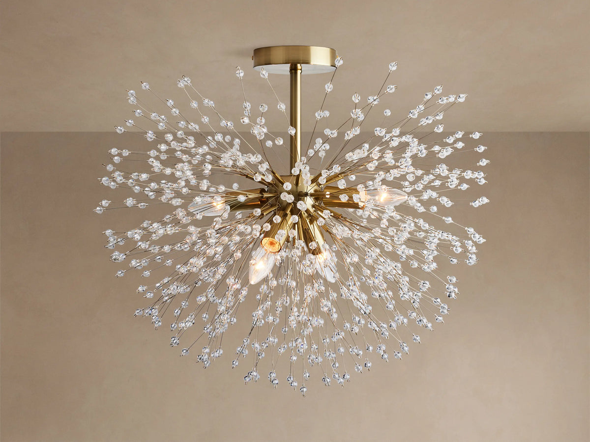 Gold Dandelion Flush Mount with sparkling clear crystal beads extending in a starburst, lights emitting warm glow on a neutral ceiling.