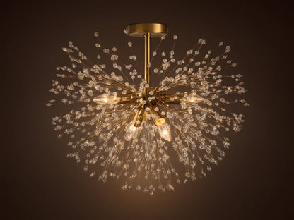 Gold Dandelion Flush Mount with sparkling clear crystal beads extending in a starburst, lights emitting warm glow on a neutral ceiling.