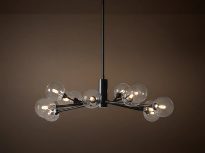 Apollo Round Chandelier: Black iron arms holding clear glass globes with illuminated bulbs, suspended on a tan background.