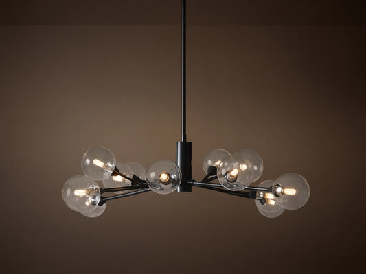 Apollo Round Chandelier: Black iron arms holding clear glass globes with illuminated bulbs, suspended on a tan background.