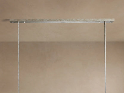 Cameron Rectangular Chandelier: Close-up of antique silver frame & multiple layers of translucent white selenite with warm light.