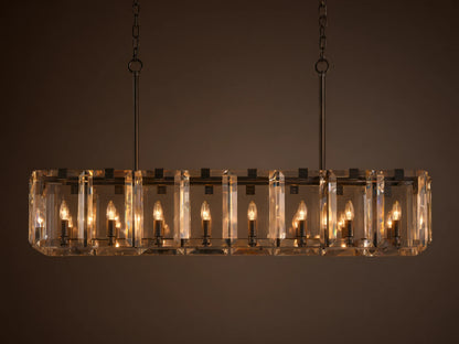 Rectangular chandelier with clear crystal panels and black iron frame, featuring twelve lit candle-style bulbs, hanging from chains.