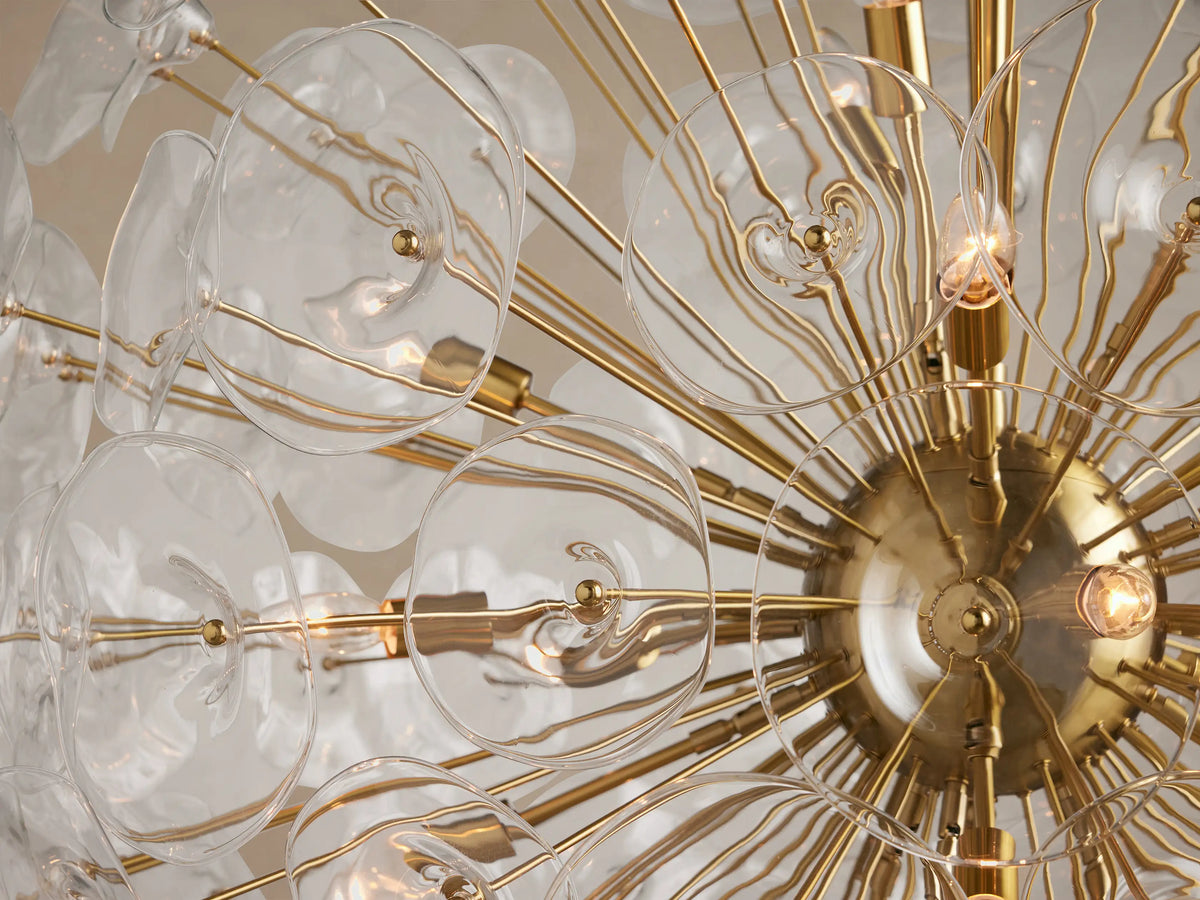 Lily Round Chandelier, gold frame with clear, translucent glass lily petals arranged spherically, suspended from above.