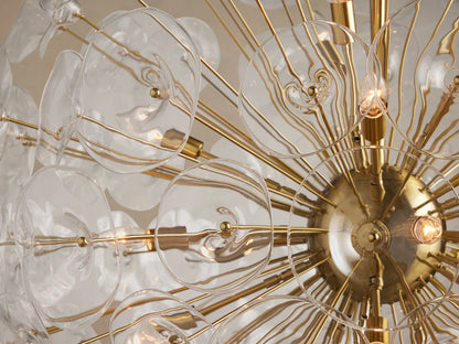 Lily Round Chandelier, gold frame with clear, translucent glass lily petals arranged spherically, suspended from above.