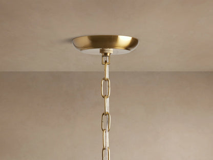 Close-up of Dandelion Round Chandelier with radiant silver rods, numerous clear glass crystals, and glowing bulbs.