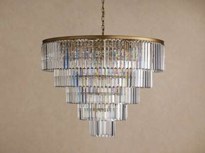 Leyland Tiered Round Chandelier, with multiple layers of rectangular clear K9 crystals glowing warmly, hanging from a dark bronze frame.