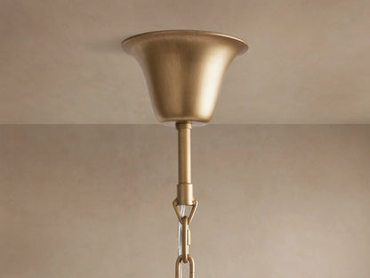 Leyland Tiered Round Chandelier close-up, showing multiple tiers of sparkling K9 glass crystals. Warm light illuminates the bronze-finished frame.