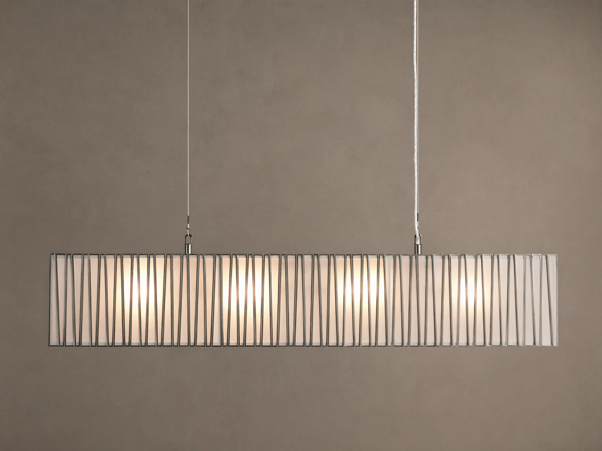 Horizontal Jeunet Rectangular Chandelier in Nickel, hanging against a tan wall, showing glowing white panels through vertical nickel bars.