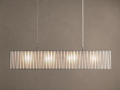 Horizontal Jeunet Rectangular Chandelier in Nickel, hanging against a tan wall, showing glowing white panels through vertical nickel bars.